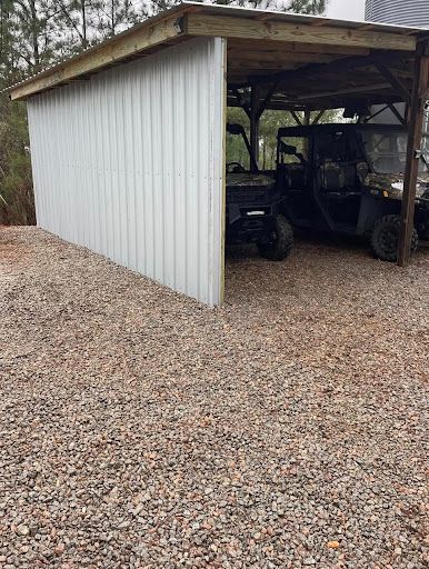 Metal-sided equipment shelter with a utility vehicle inside