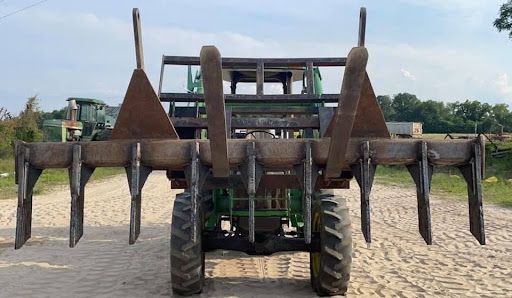 Welded agricultural attachment mounted on a tractor