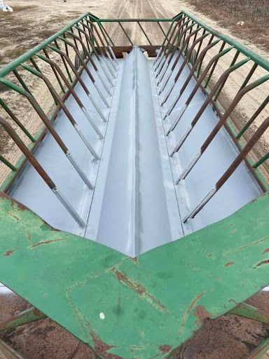 Freshly fabricated sheet-metal channel between steel rails