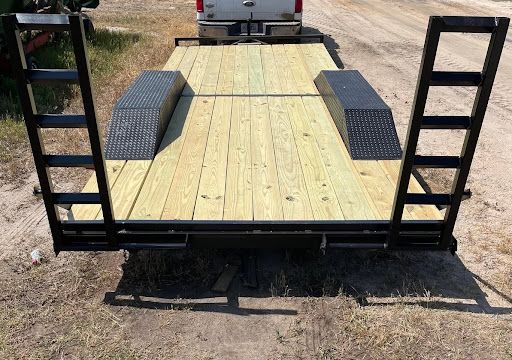Utility trailer with a new wood deck and black steel fenders
